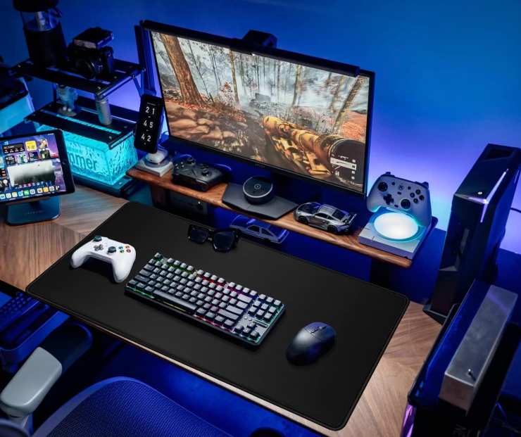 Una postazione da gaming completa con schermo, console, mouse, tastiera e tablet